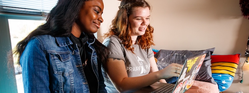 Two students looking at computer